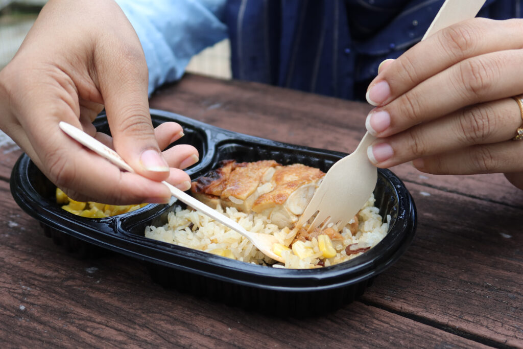 Curry chicken and rice in a take away plastic packet on table